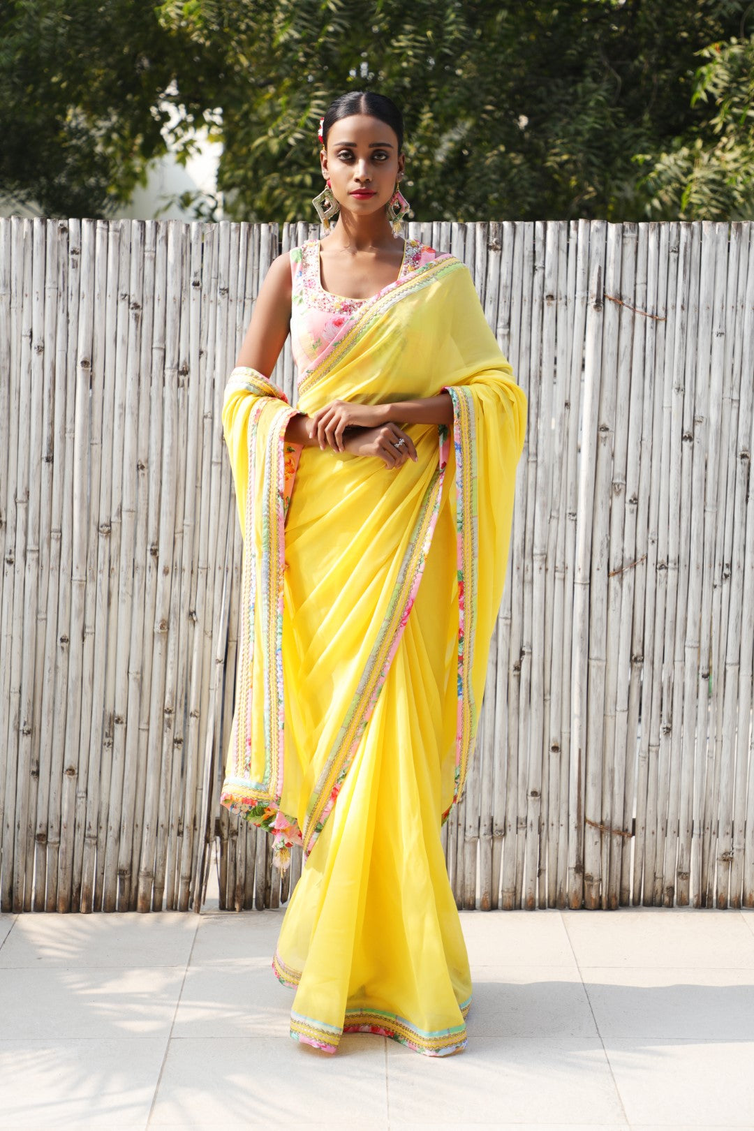 Plain pitambri yellow georgette saree with vintage rose and checks border.