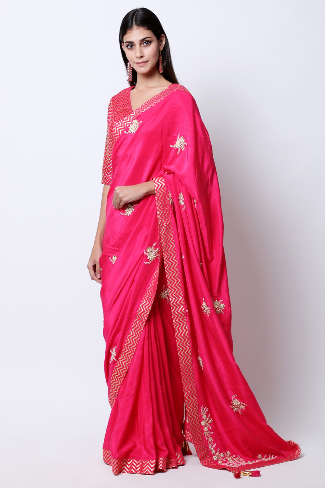 Rani Pink kisti and dabka hand embroidered silk saree , paired with gold chevron embroidered blouse.