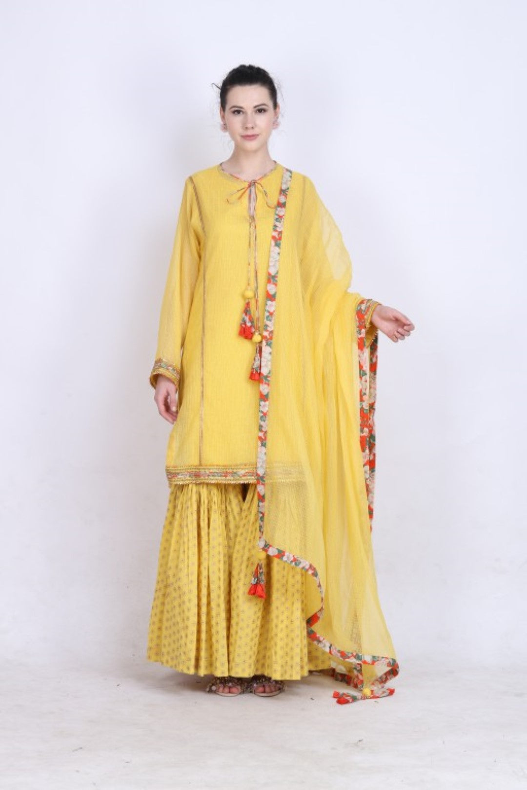 Pitambari yellow kota doria kurta with a gold foil printed gathered sharara and kota doria dupatta.