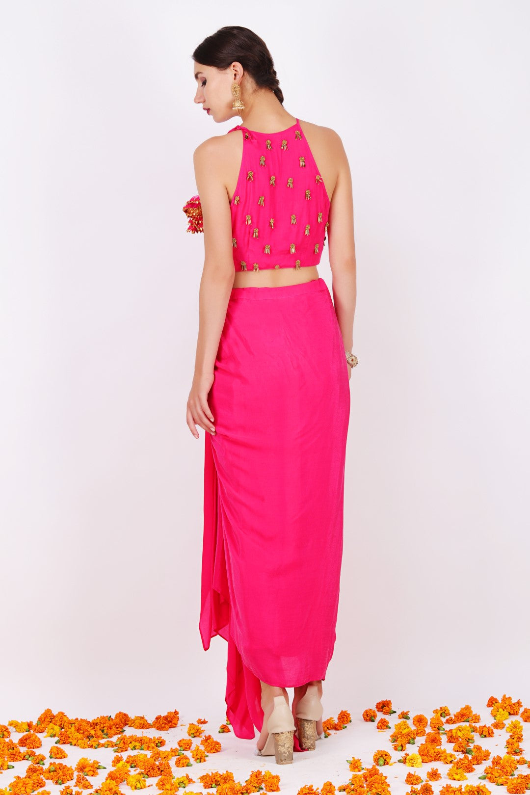 Rani pink crepe embroidered halter crop top with rani pink crepe draped skirt.