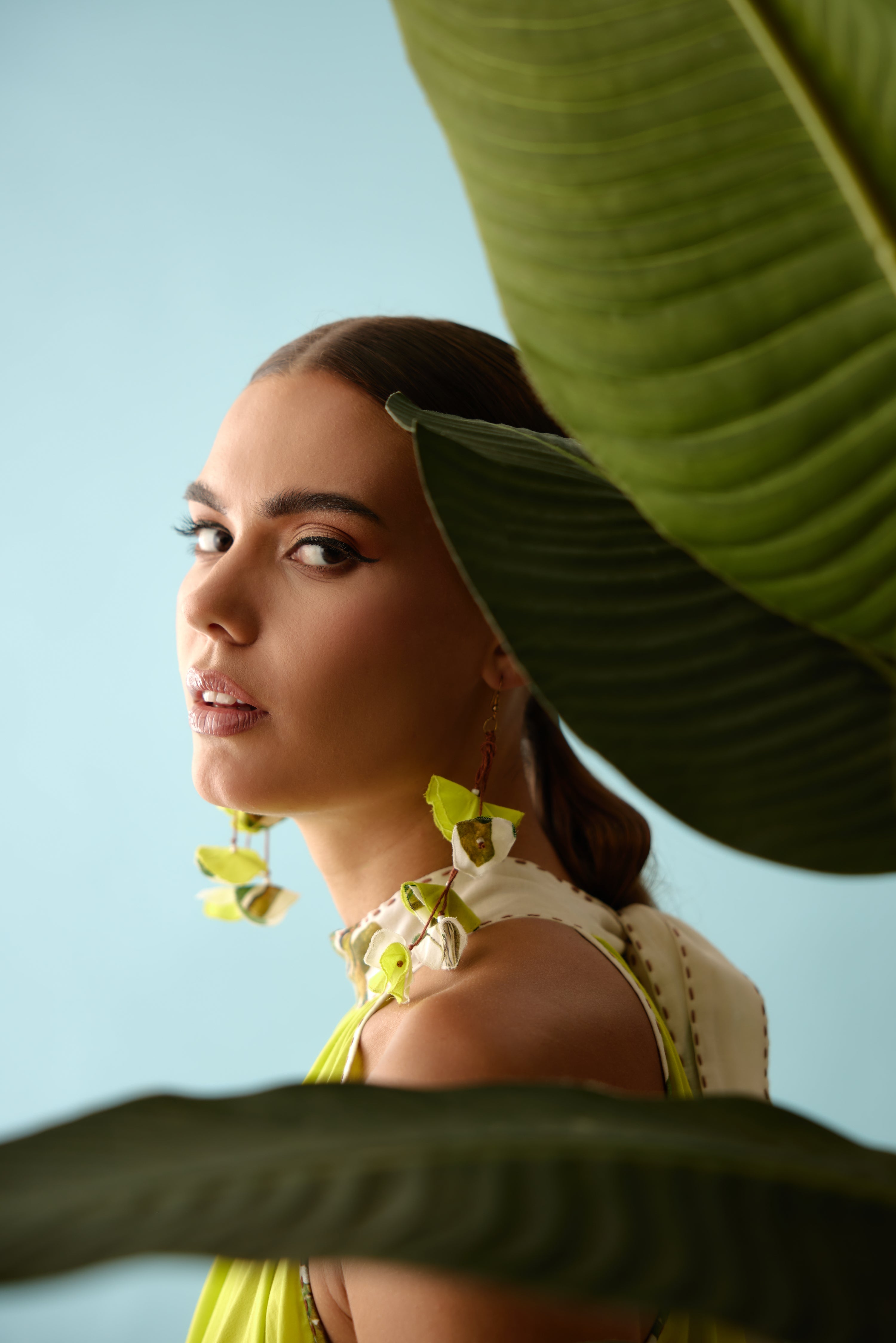 Lime green recycled asymmetrical banana tree print tassels earrings.