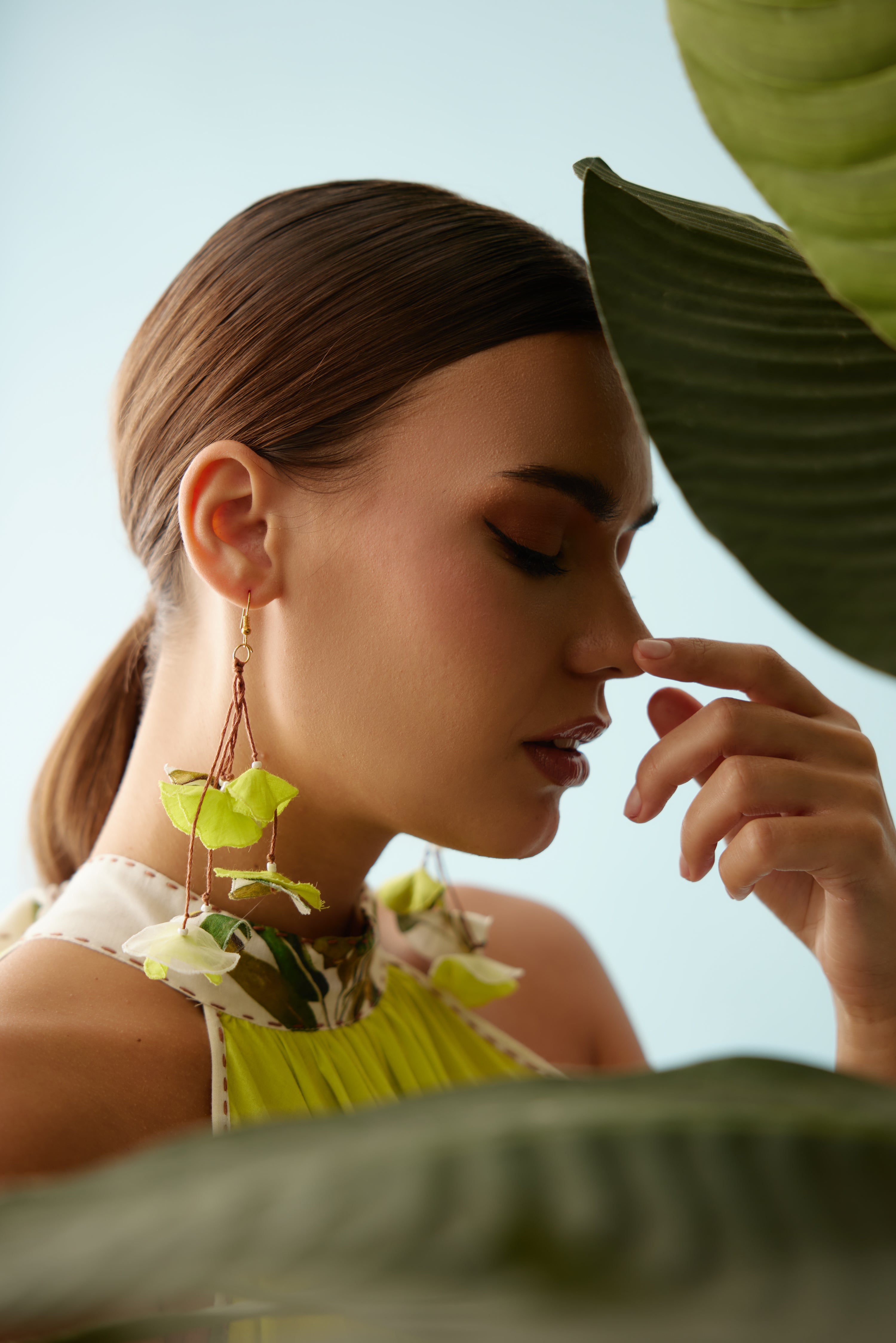 Lime green recycled asymmetrical banana tree print tassels earrings.