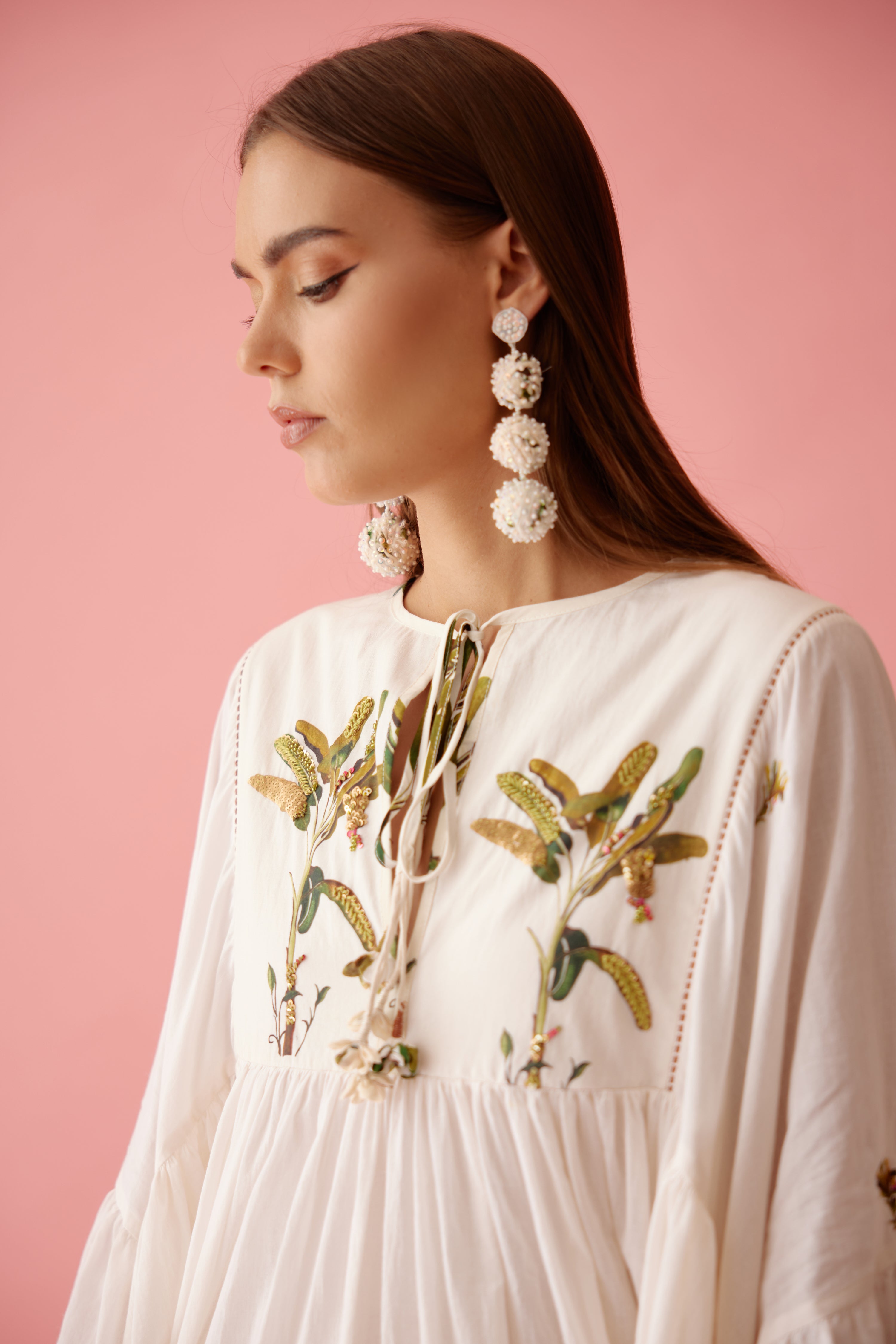 Cream recycled hand embroidered earrings higlighted with sequins and ivory pearls.