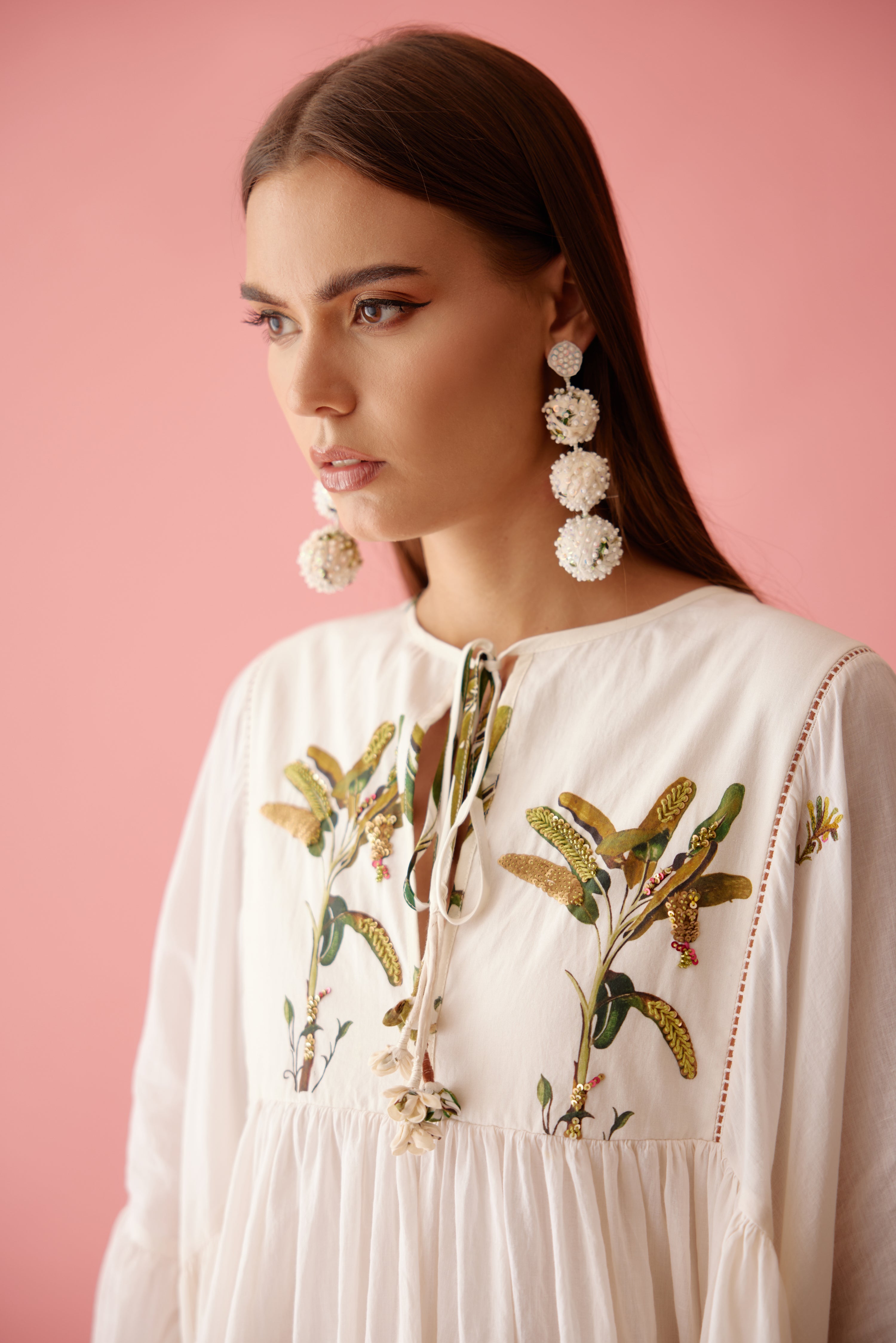 Cream recycled hand embroidered earrings higlighted with sequins and ivory pearls.