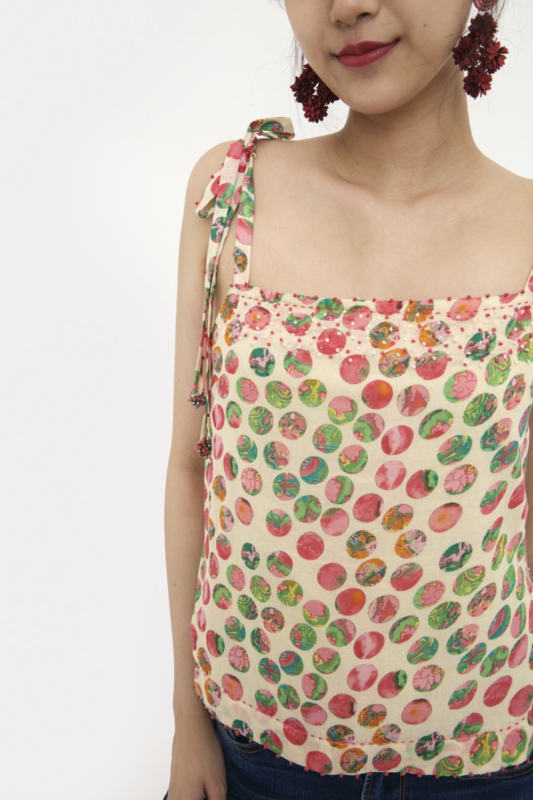 "Handwove cream hand-painted polka dot printed camisole in handwoven cotton silk, embellished with french knots and sequins. 100% Handwoven cotton silk; Lining: 100% cotton 100% Azo Free Dry Clean Only"