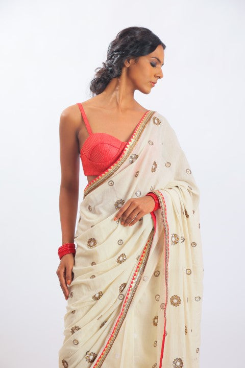 IVORY HANDWOVEN JAMDANI SAREE PAIRED WITH SINDOORI RED RAW SILK BRALETTE.