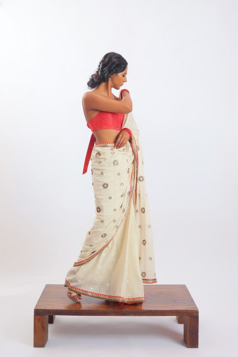 IVORY HANDWOVEN JAMDANI SAREE PAIRED WITH SINDOORI RED RAW SILK BRALETTE.