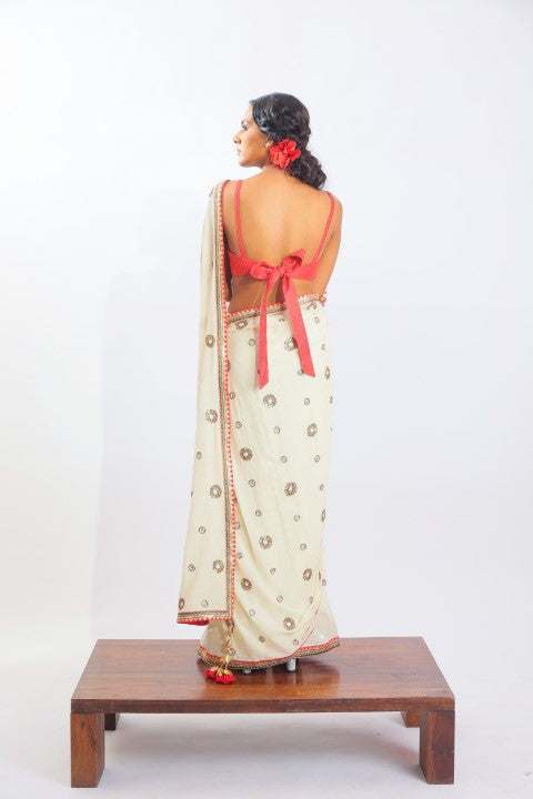 IVORY HANDWOVEN JAMDANI SAREE PAIRED WITH SINDOORI RED RAW SILK BRALETTE.