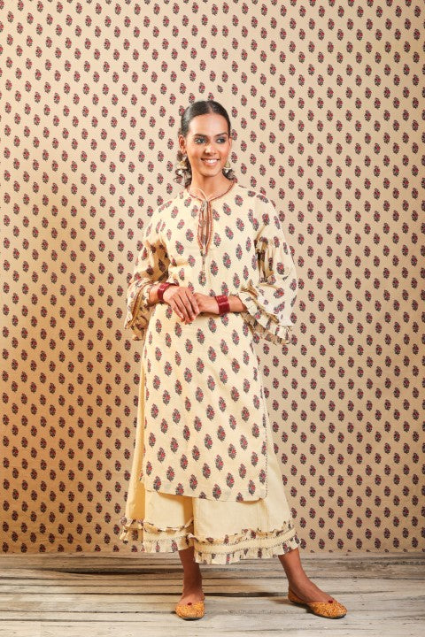 BEIGE SOFT COTTON KURTA PAIRED WITH WIDTH LENGTH PANTS.