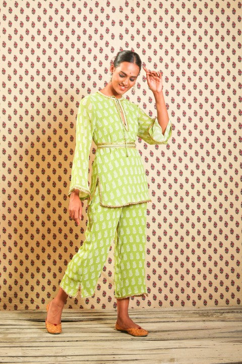 LIME GREEN GEORGETTE KURTA PAIRED WITH STRAIGHT PANTS AND BELT.