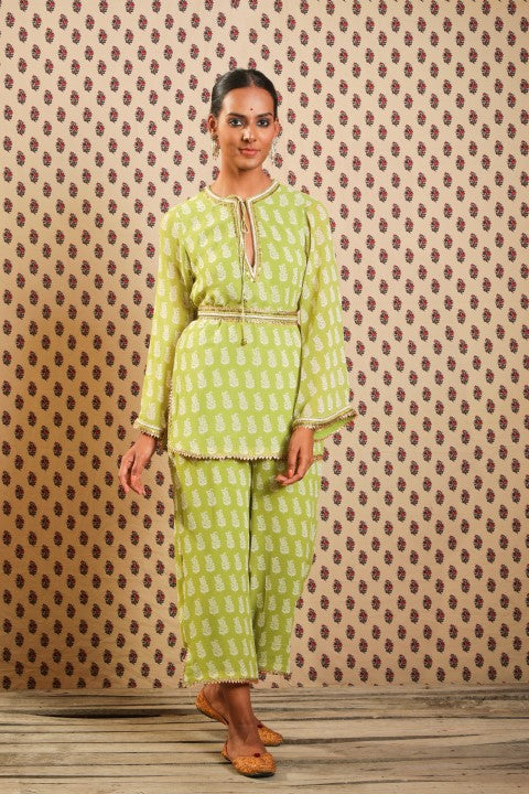 LIME GREEN GEORGETTE KURTA PAIRED WITH STRAIGHT PANTS AND BELT.