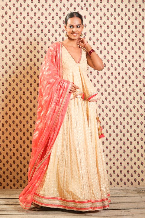 LIGHT CAMEL PEPLUM BLOUSE PAIRED WITH LOTUS PRINT LEHENGA DUPATTA.