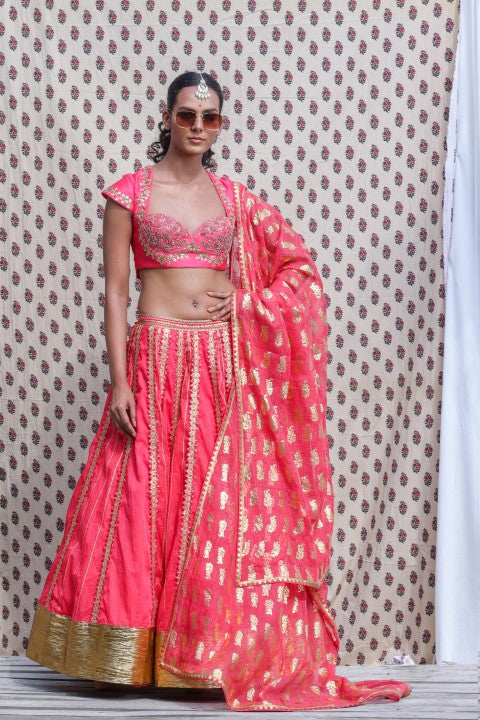 CORAL RED COTTON SILK BLOUSE PAIRED WITH ORGANDI LEHENGA AND KOTA DORIA DUPATTA.