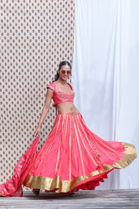 CORAL RED COTTON SILK BLOUSE PAIRED WITH ORGANDI LEHENGA AND KOTA DORIA DUPATTA.