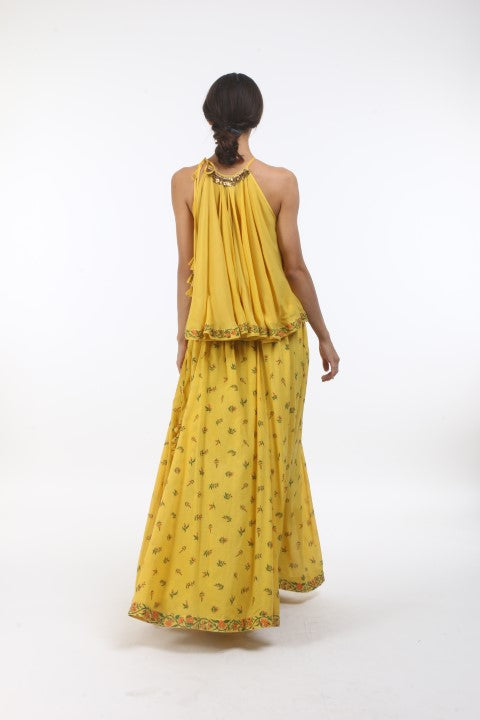 Bloom pitambari yellow flared halter top in crepe, with bouquet printed cotton lehenga in layered coin embroidered neckline.