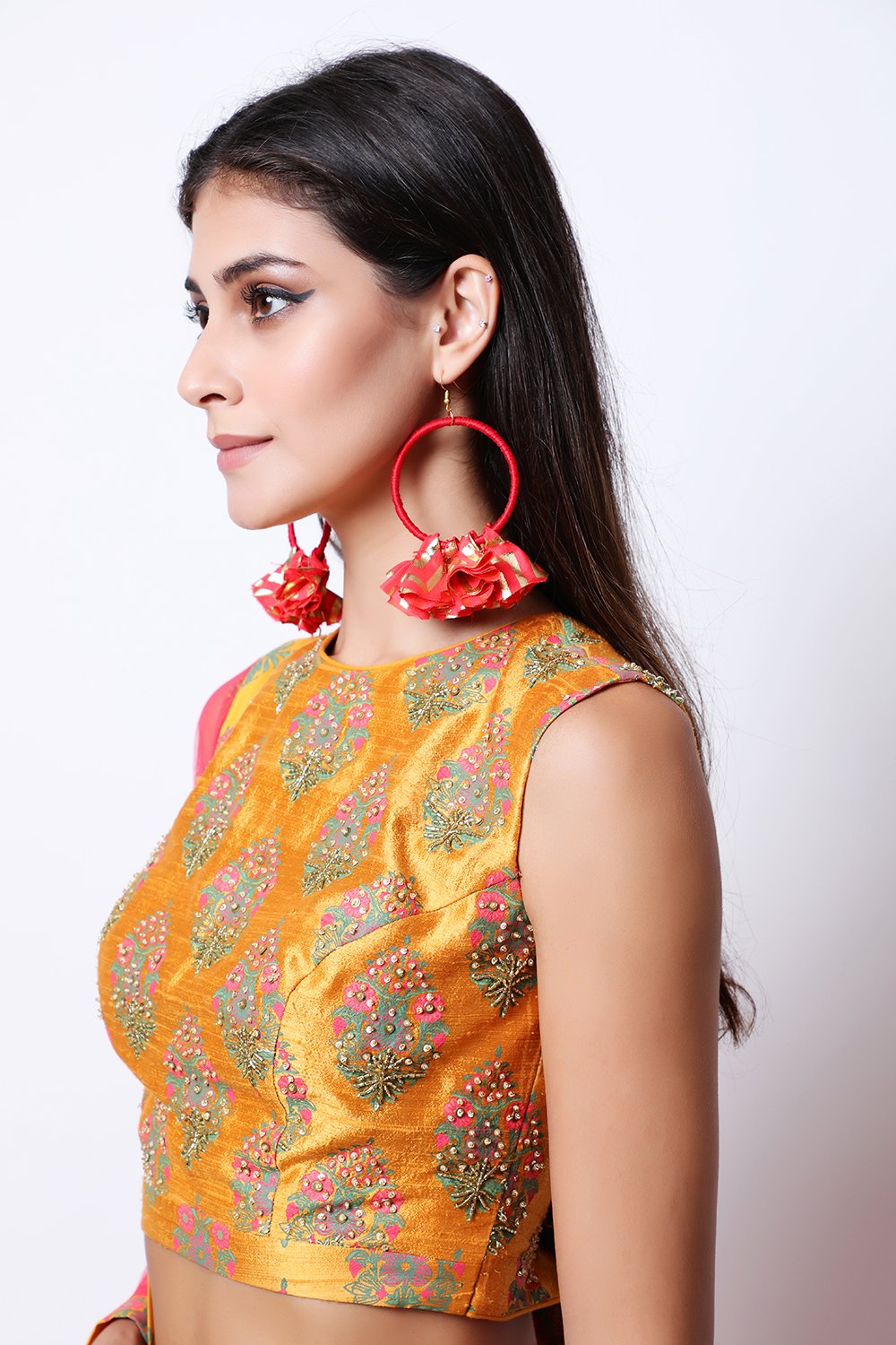 Ochre hand-printed blouse with printed organza top layer skirt with ochre border and dupatta.