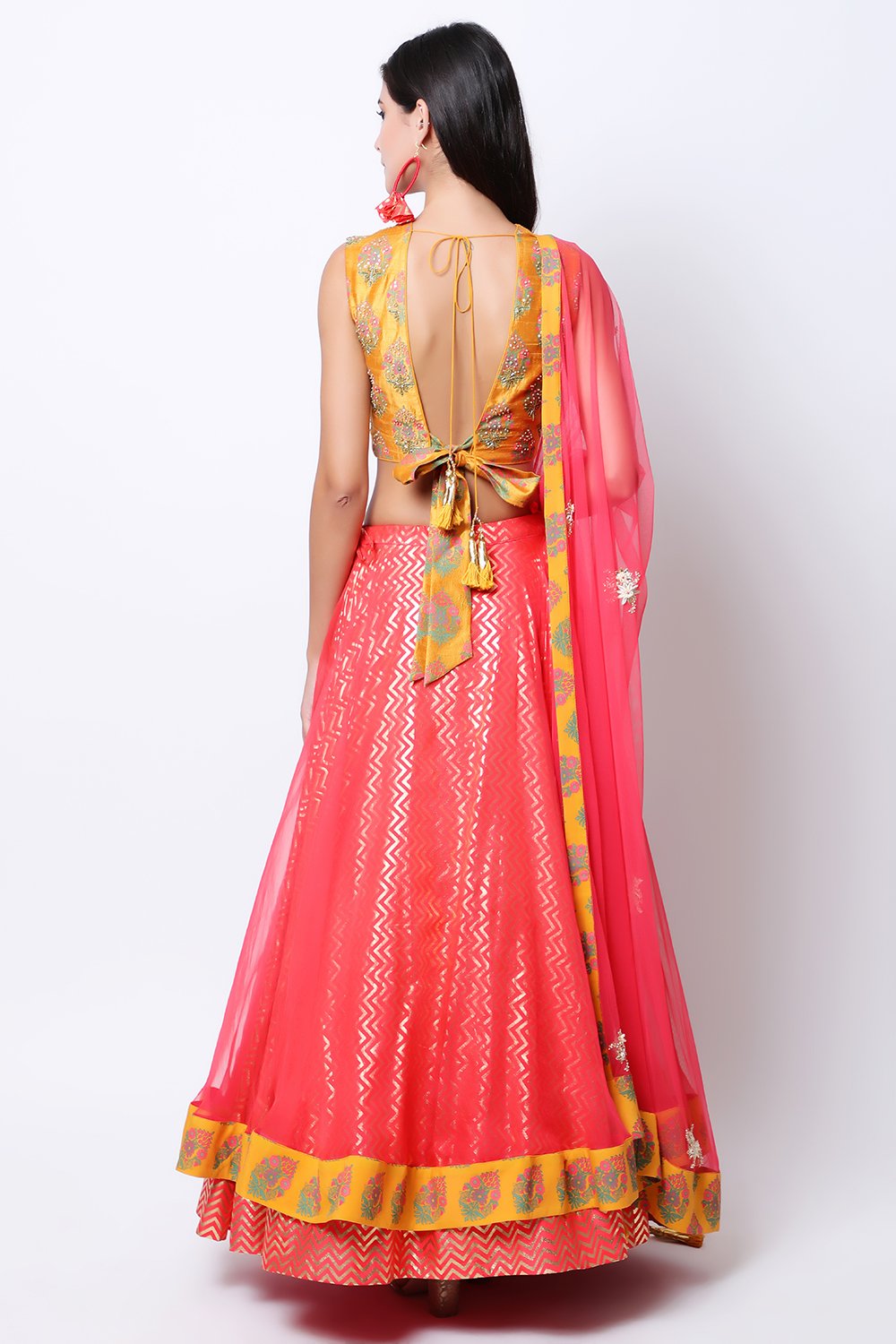Ochre hand-printed blouse with printed organza top layer skirt with ochre border and dupatta.