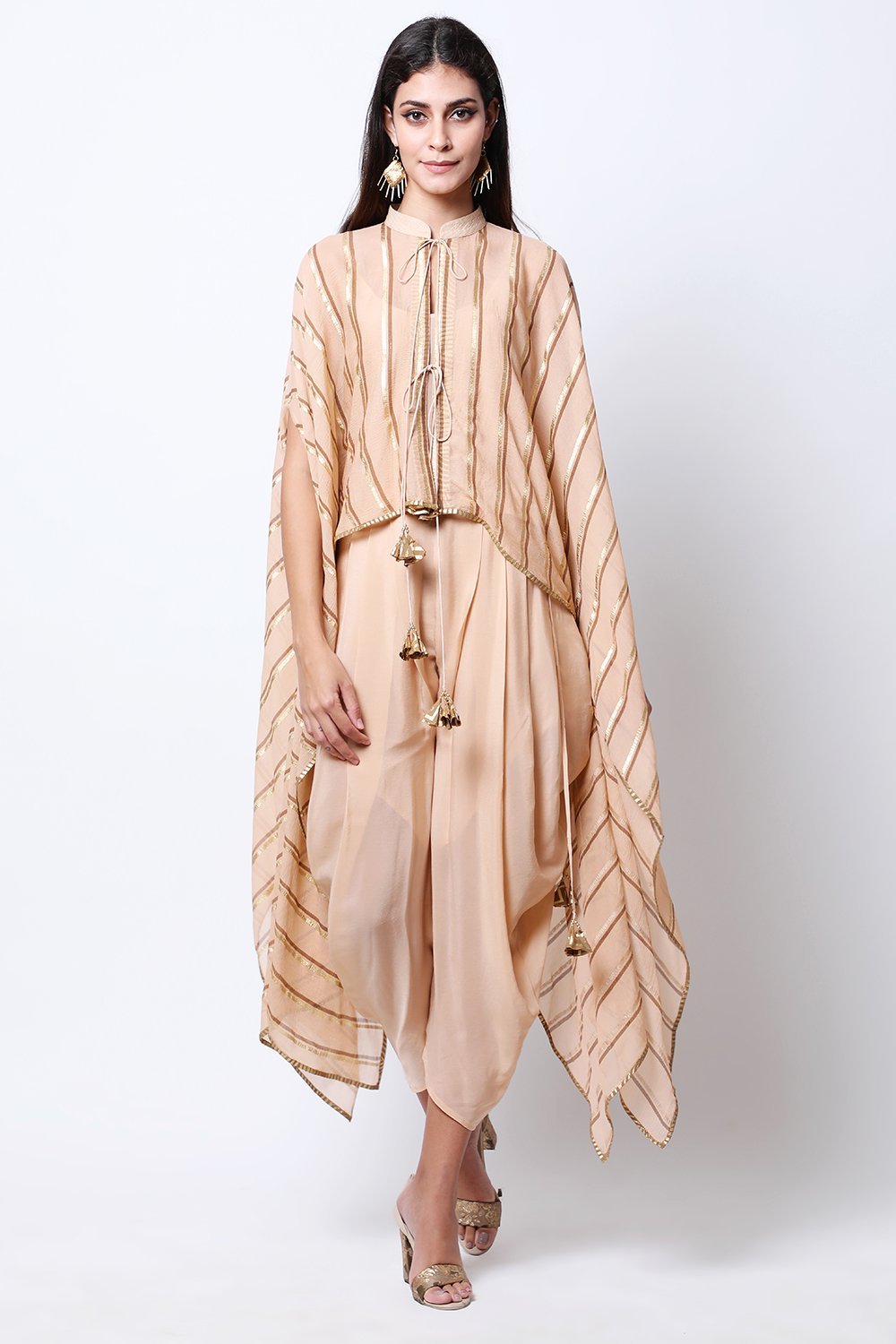 Light Tabacco leheriya cape , paired with crop top and cowl dhoti.