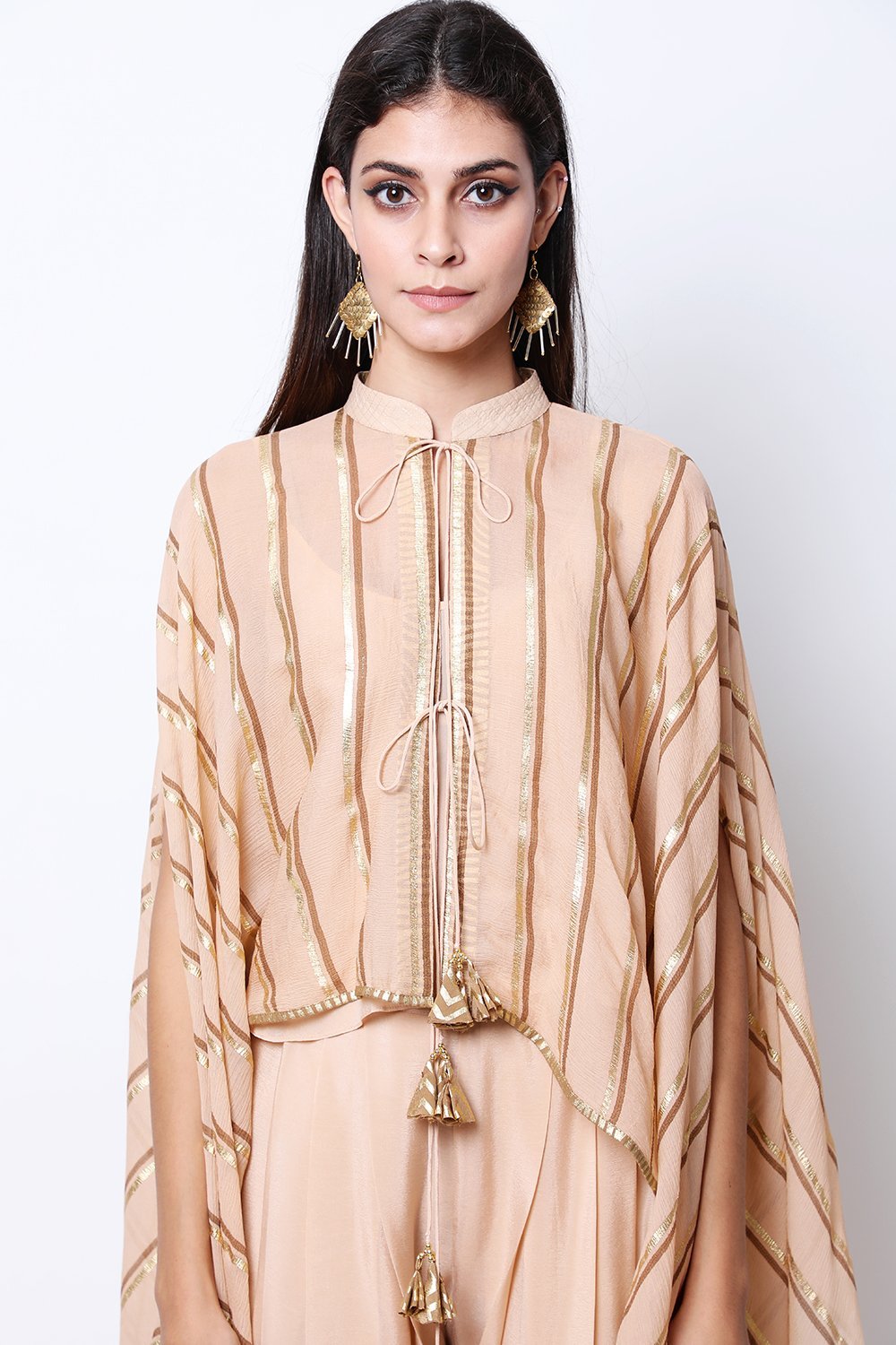 Light Tabacco leheriya cape , paired with crop top and cowl dhoti.