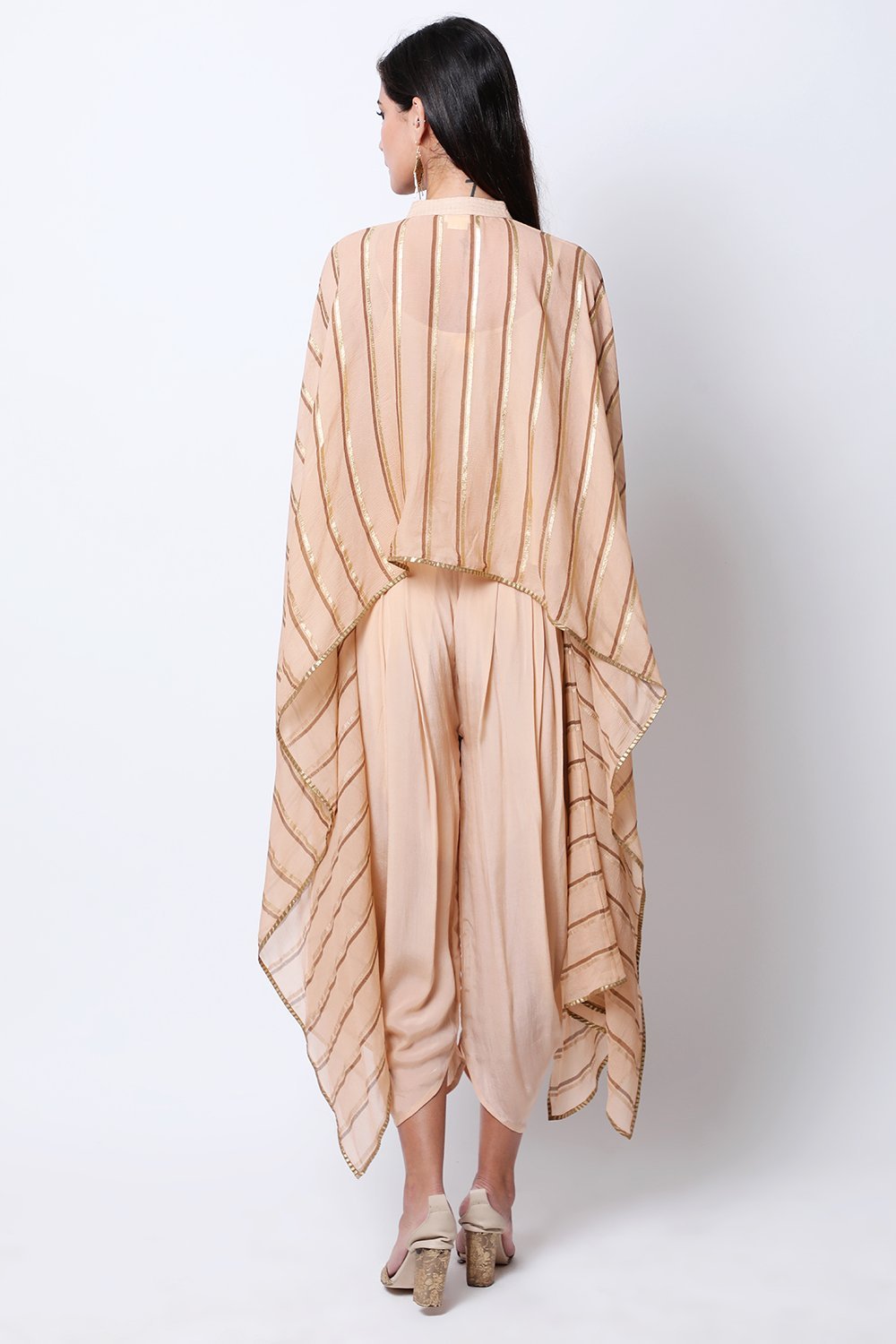 Light Tabacco leheriya cape , paired with crop top and cowl dhoti.