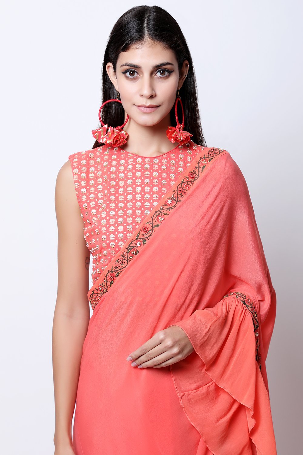 Gajari Coral frill saree with bel detail , paired with chotu sanga gold printed hand-embroidered blouse.