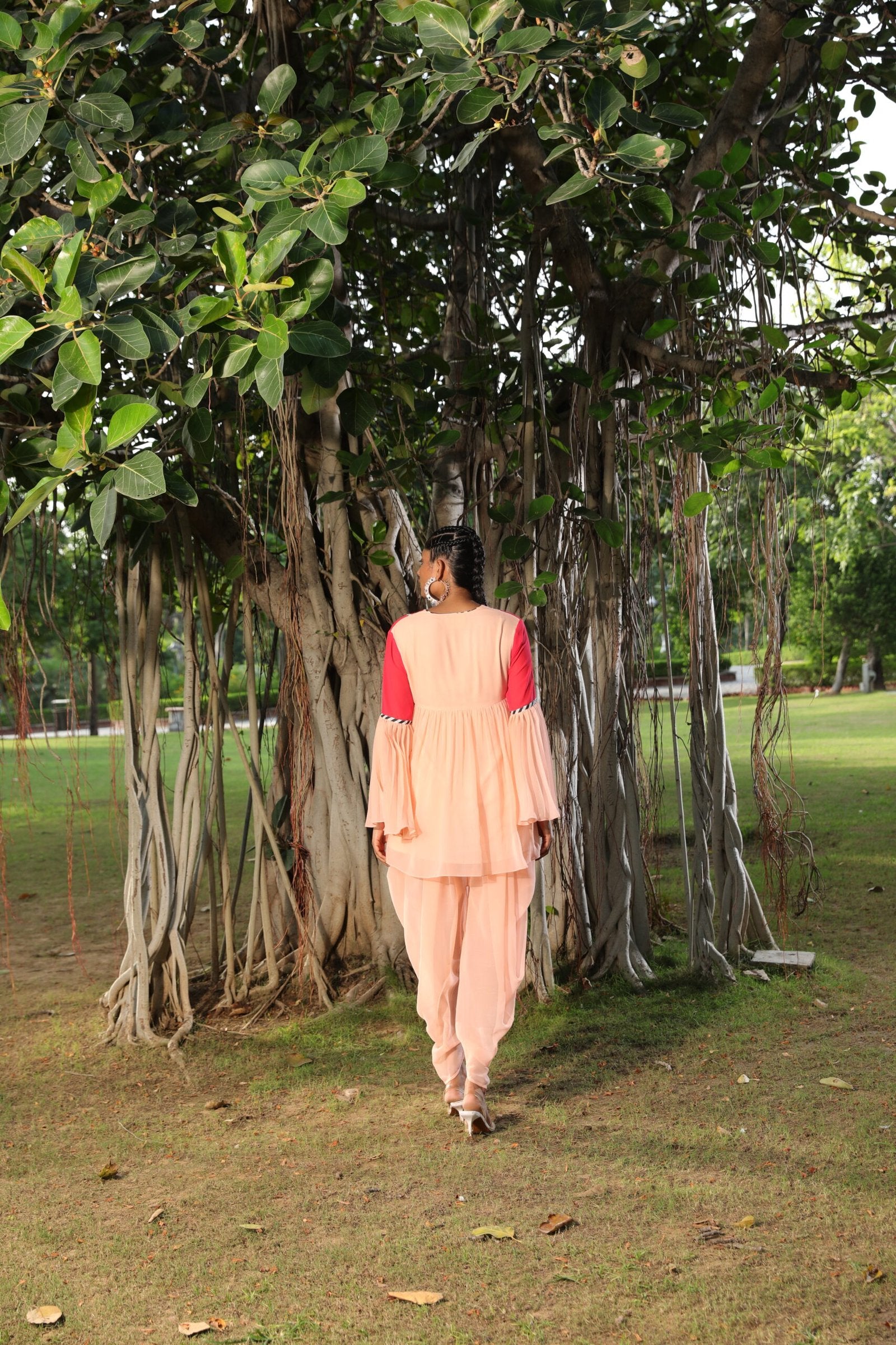Peach and coral tunic paired with dhoti