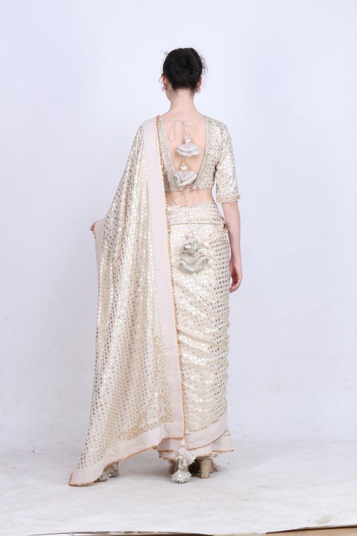 Crepe ghee gold foil printed saree with embroidered palla paired with blouse.