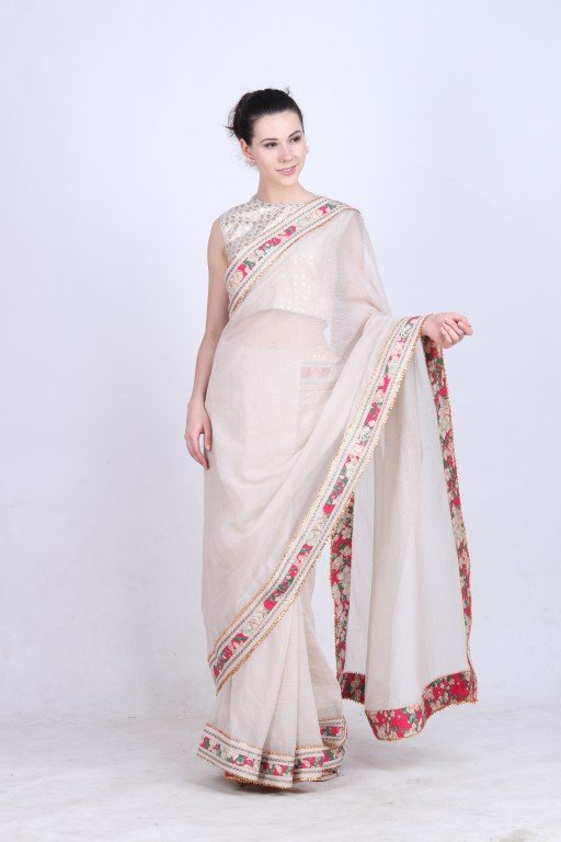 Ghee kota doria saree paired with a gold foil printed blouse .