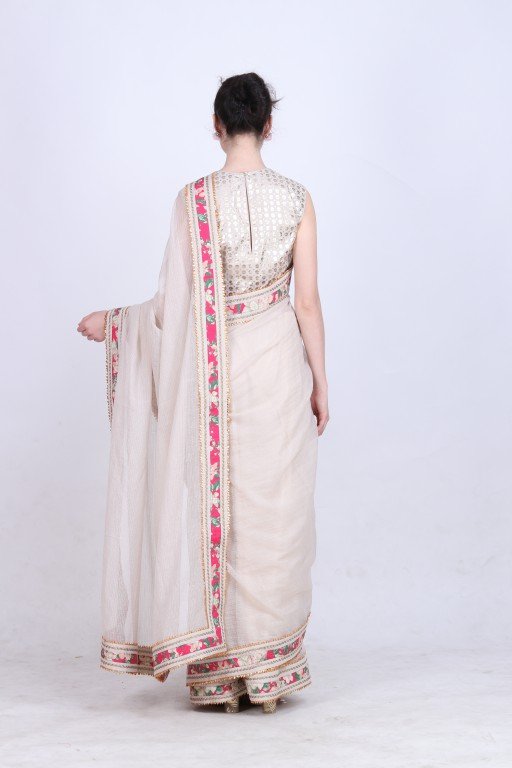 Ghee kota doria saree paired with a gold foil printed blouse .