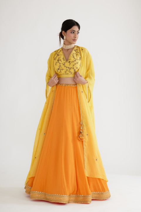 Ochre Yellow Lehenga paired with Yellow Blouse and Cape