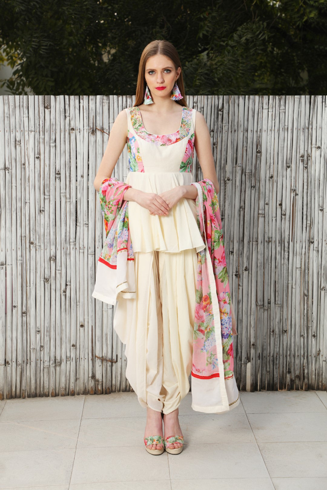 Ivory cotton silk peplum top teamed with cowl dhoti and a mithai pink vintage rose dupatta.