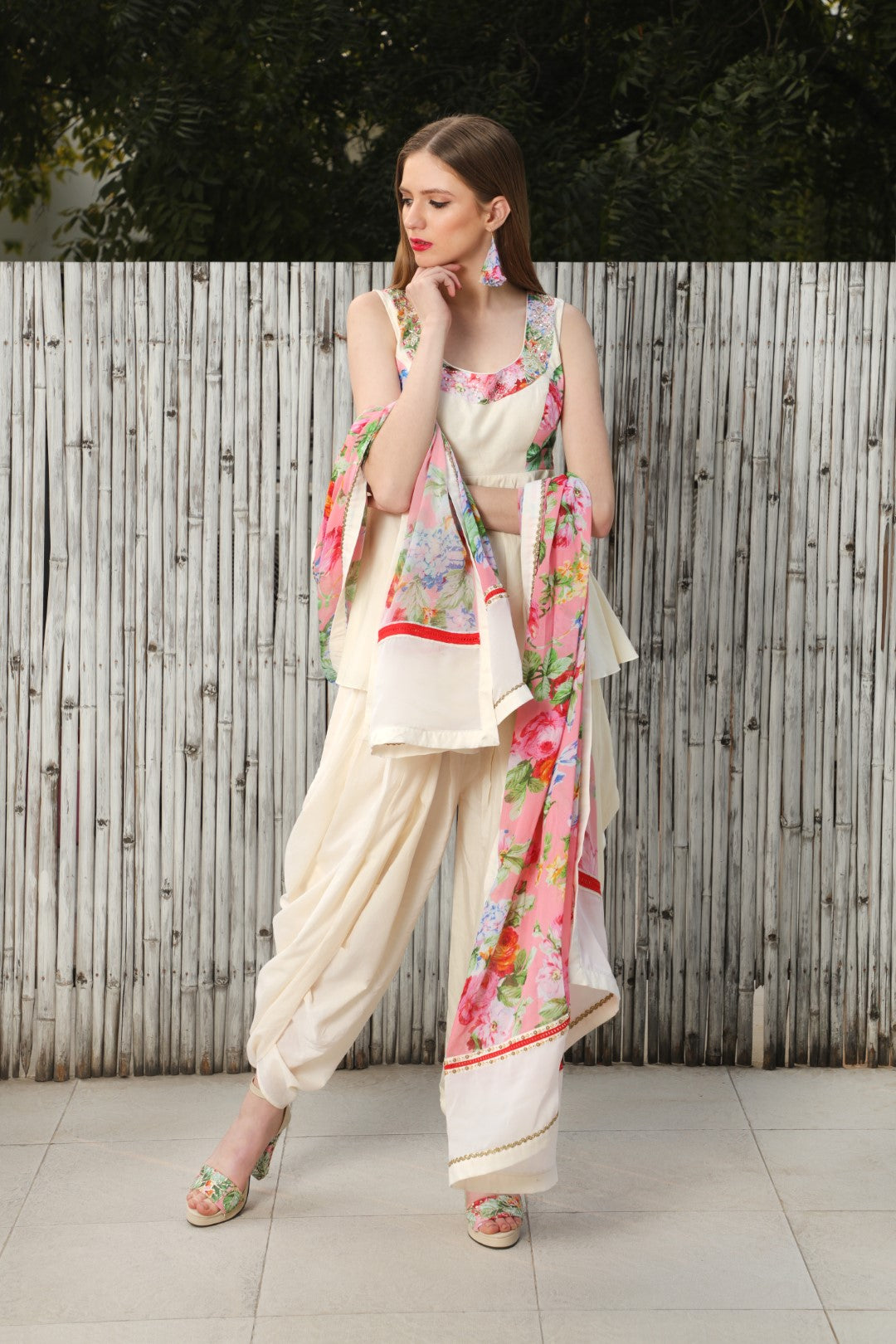 Ivory cotton silk peplum top teamed with cowl dhoti and a mithai pink vintage rose dupatta.