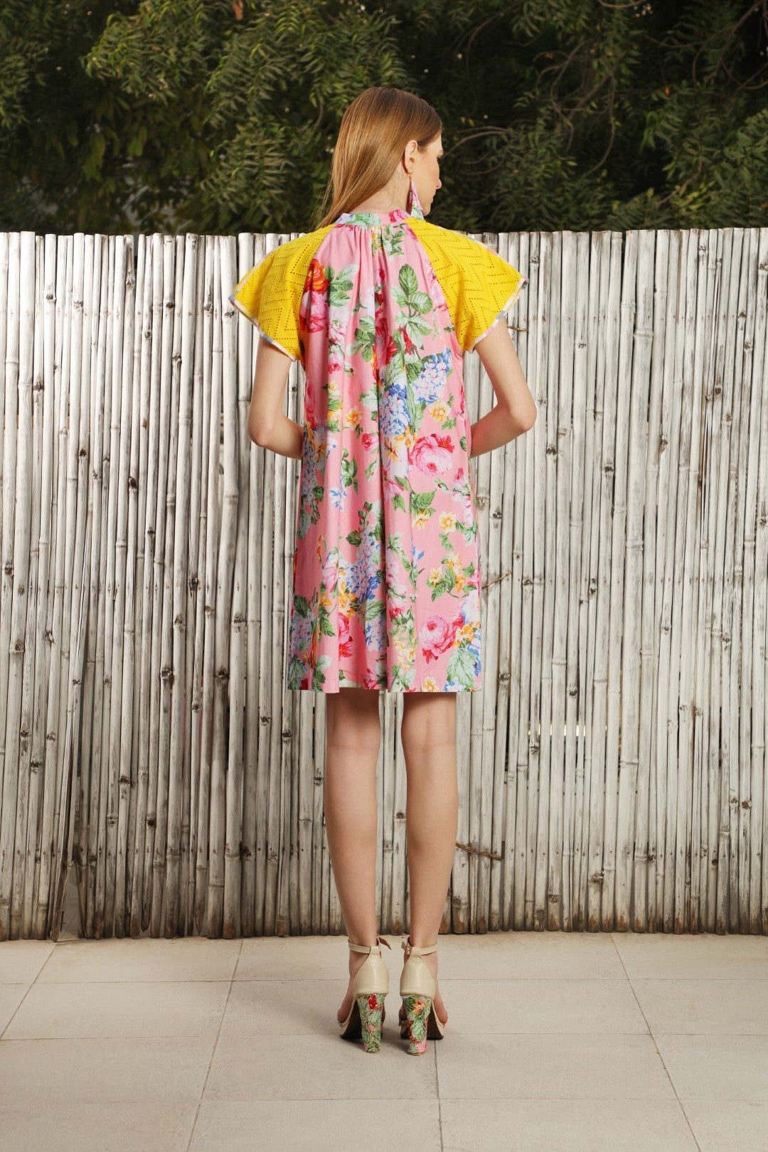 A mithai pink poplin dress with yellow eyelet on sleeves.