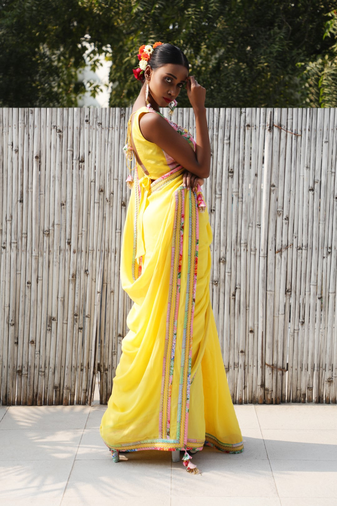 Plain pitambri yellow georgette saree with vintage rose and checks border.