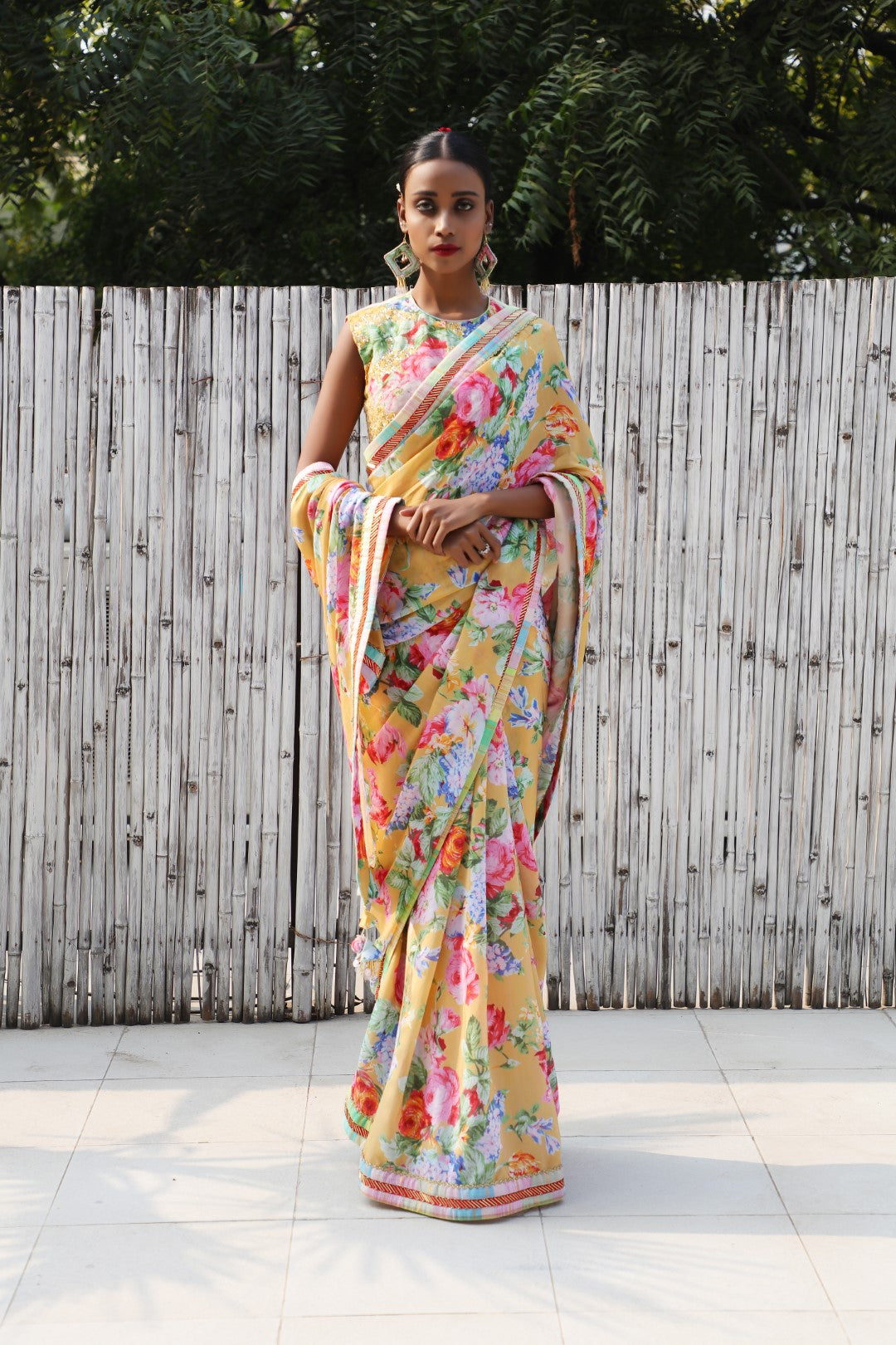 Ochre vintage rose crepe saree  teamed with an embroidered sleeveless blouse.