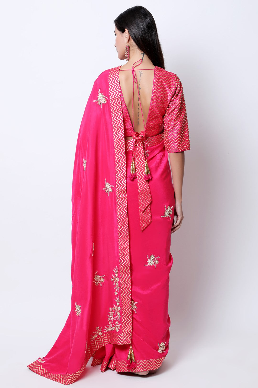 Rani Pink kisti and dabka hand embroidered silk saree , paired with gold chevron embroidered blouse.