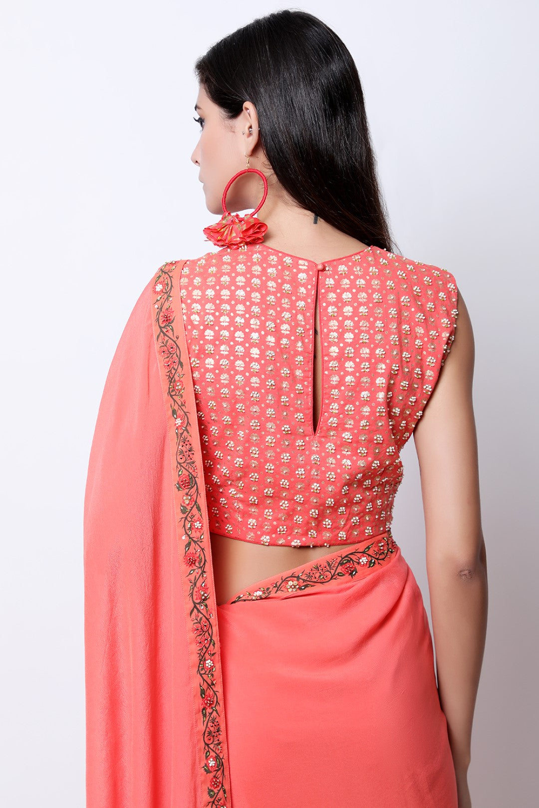 Gajari Coral frill saree with bel detail , paired with chotu sanga gold printed hand-embroidered blouse.