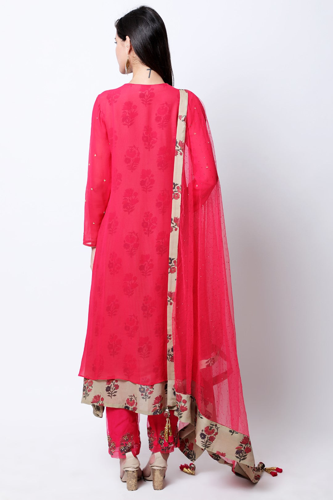 Rose red double layered  asymmetric tunic , paired with mukesh dupatta and pants.