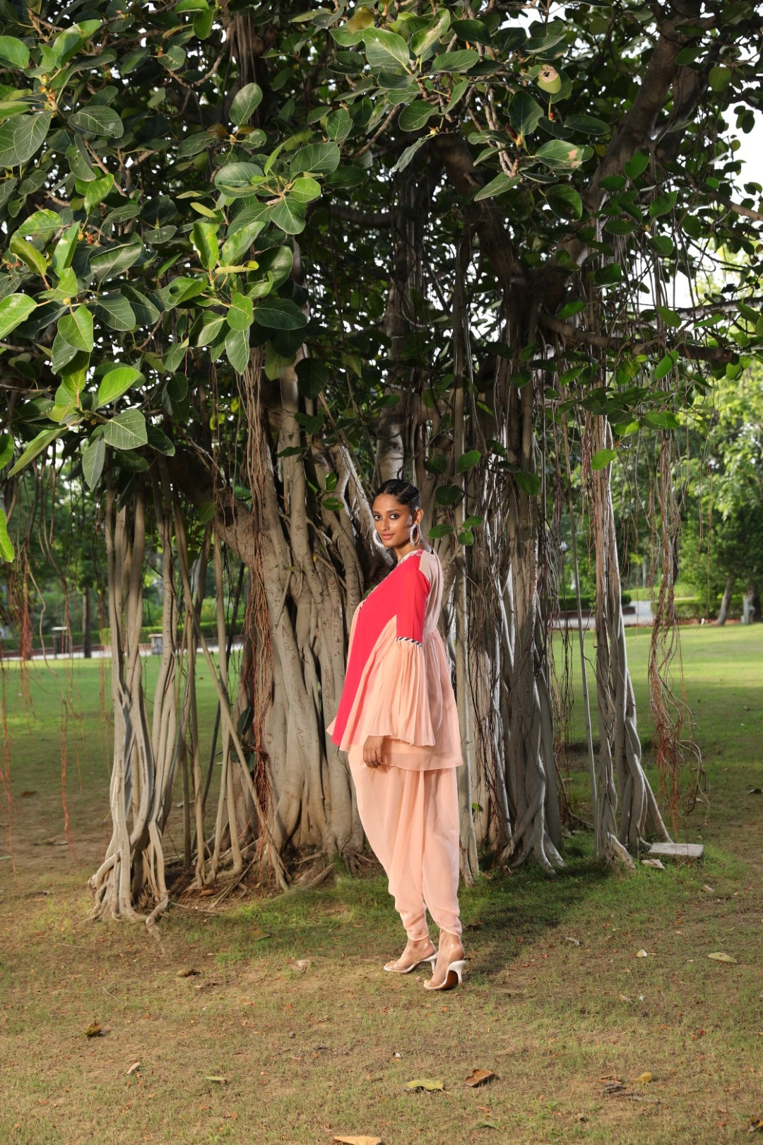 Peach and coral tunic paied with dhoti
