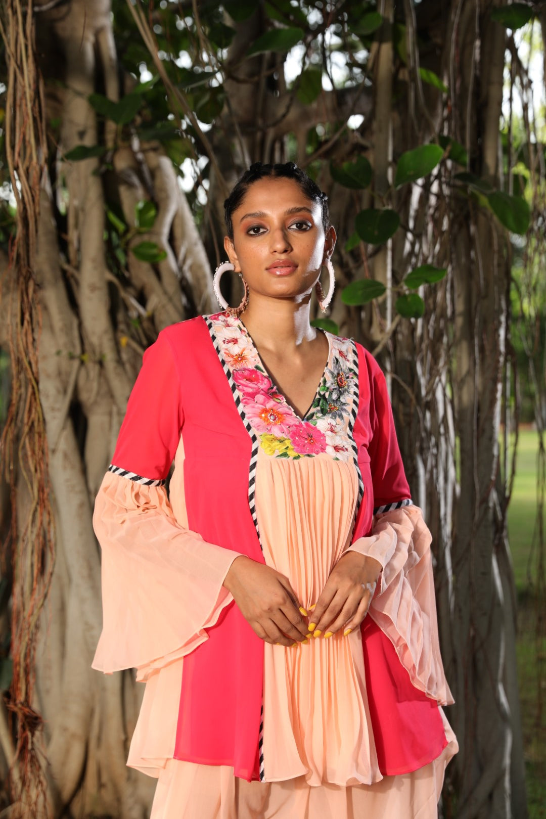 Peach and coral tunic paied with dhoti