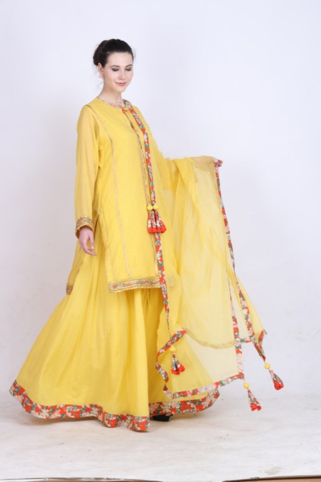 Pitambari yellow kota doria kurta with cotton silk skirt and kota doria dupatta.