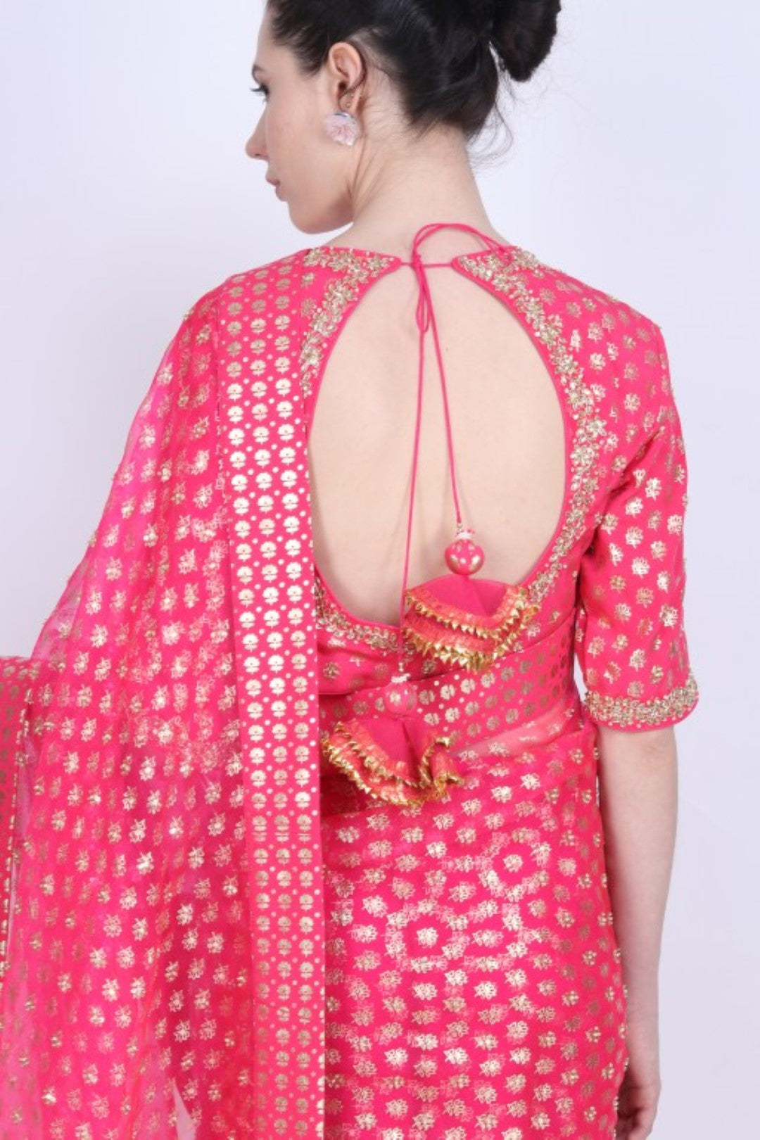 Crepe hot pink printed organza saree with a gold foil printed blouse