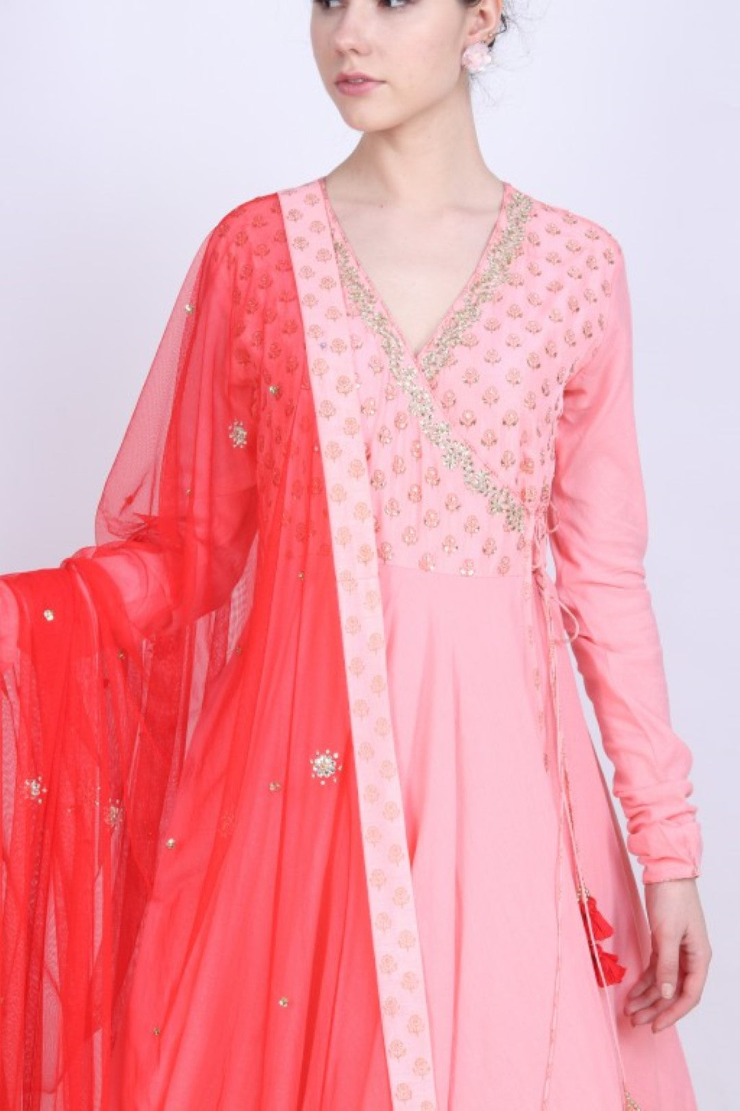 Rose pink printed angrakha paired with an embroidered net dupatta and churidar.