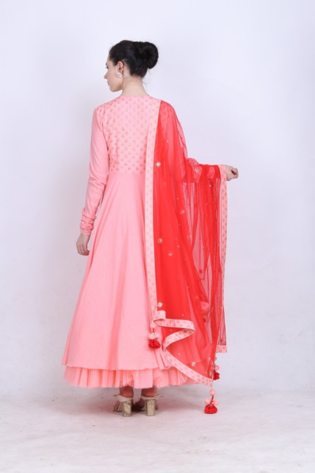 Rose pink printed angrakha paired with an embroidered net dupatta and churidar.