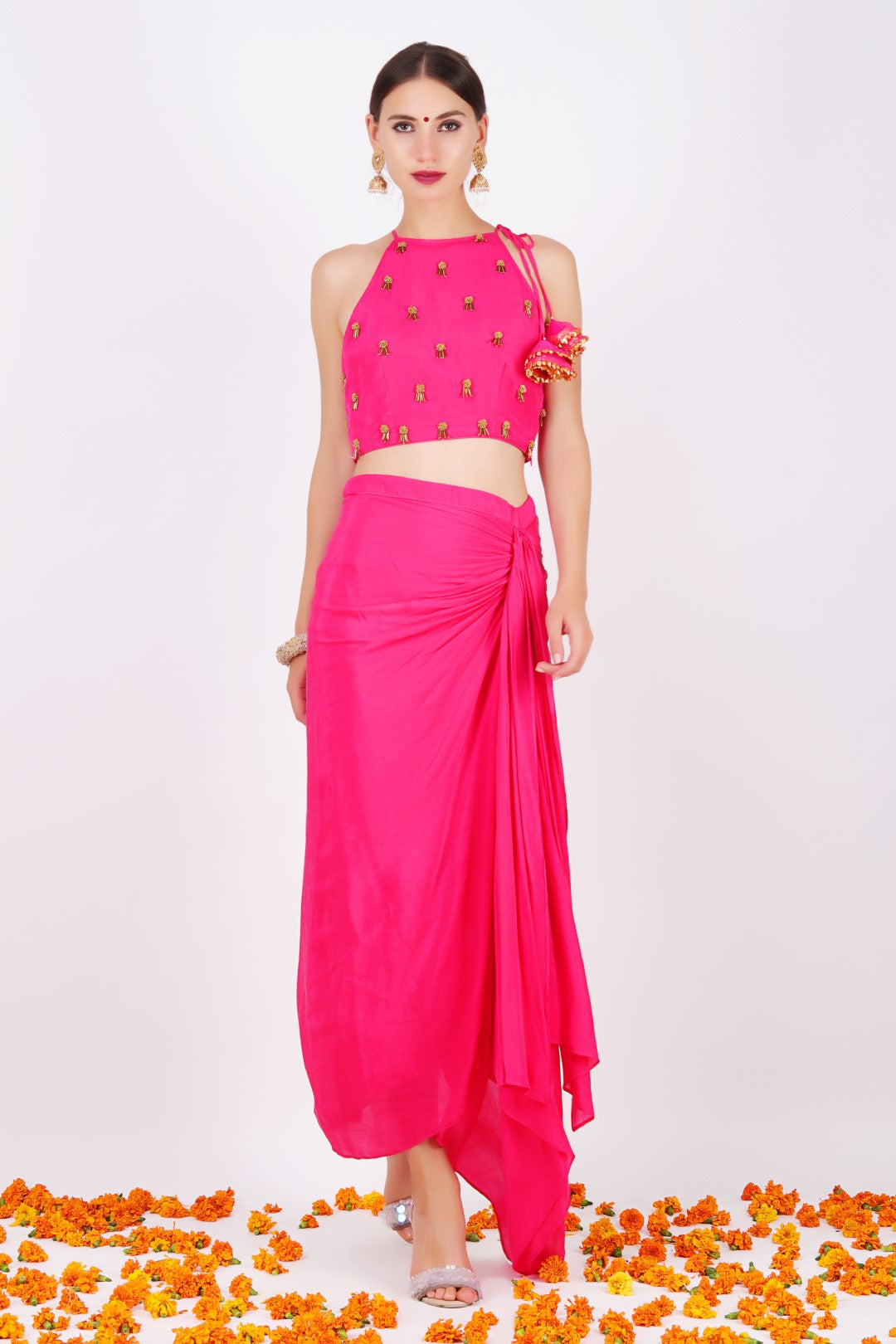 Rani pink crepe embroidered halter crop top with rani pink crepe draped skirt.