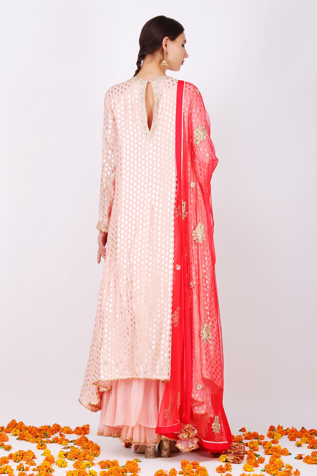 Rose pink crepe foil printed asymmetrical tunic with sharara and gajari net embroidered dupatta.