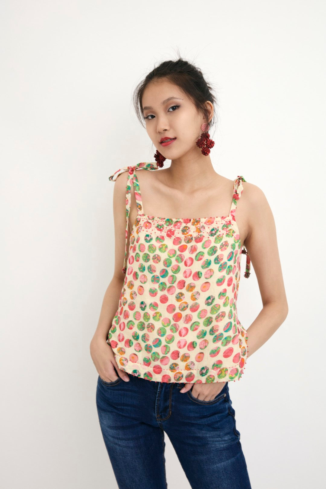 "Handwove cream hand-painted polka dot printed camisole in handwoven cotton silk, embellished with french knots and sequins. 100% Handwoven cotton silk; Lining: 100% cotton 100% Azo Free Dry Clean Only"