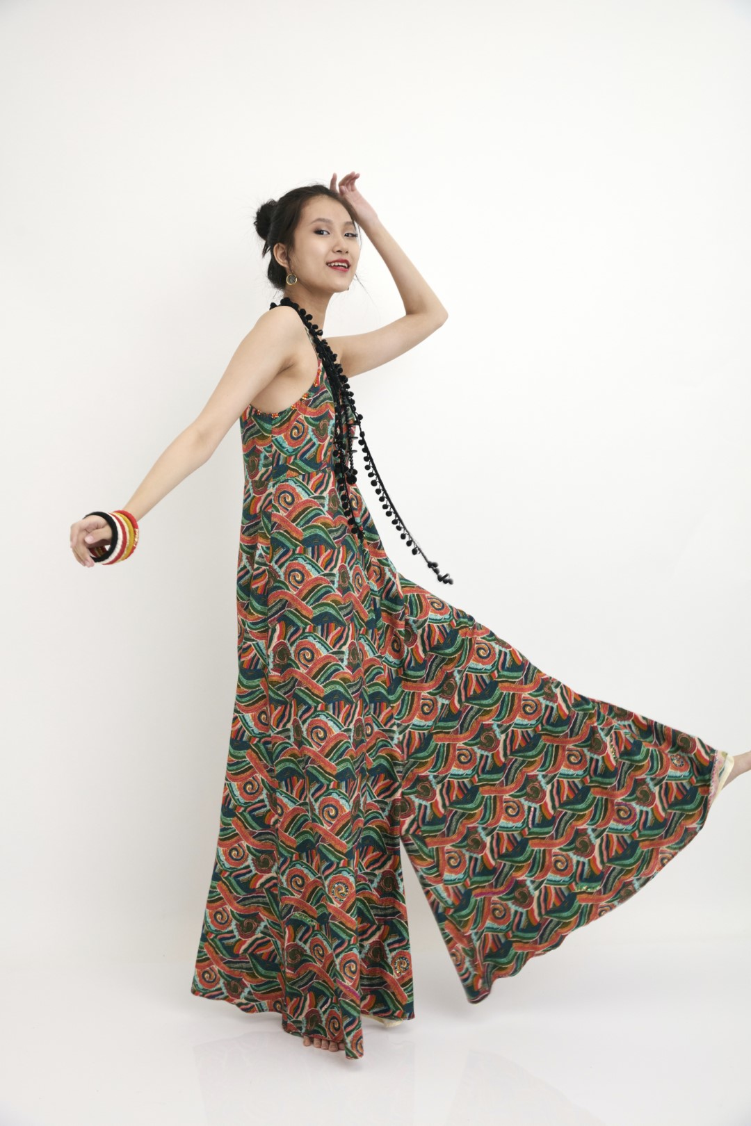 "Hand-painted iconic ocean-wave strap detail jumpsuit with hand embroidery french knots and flower detail.  100% Handwoven cotton 100% Azo Free Dry Clean Only"