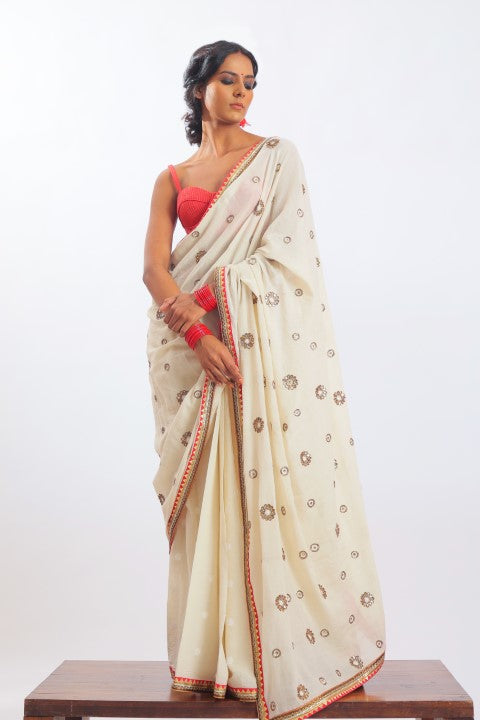 IVORY HANDWOVEN JAMDANI SAREE PAIRED WITH SINDOORI RED RAW SILK BRALETTE.