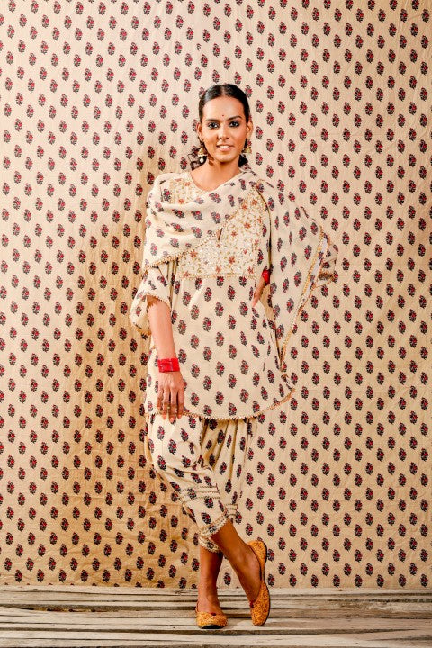 BEIGE KURTA PAIRED WITH SALWAR PANTS AND SCARF.